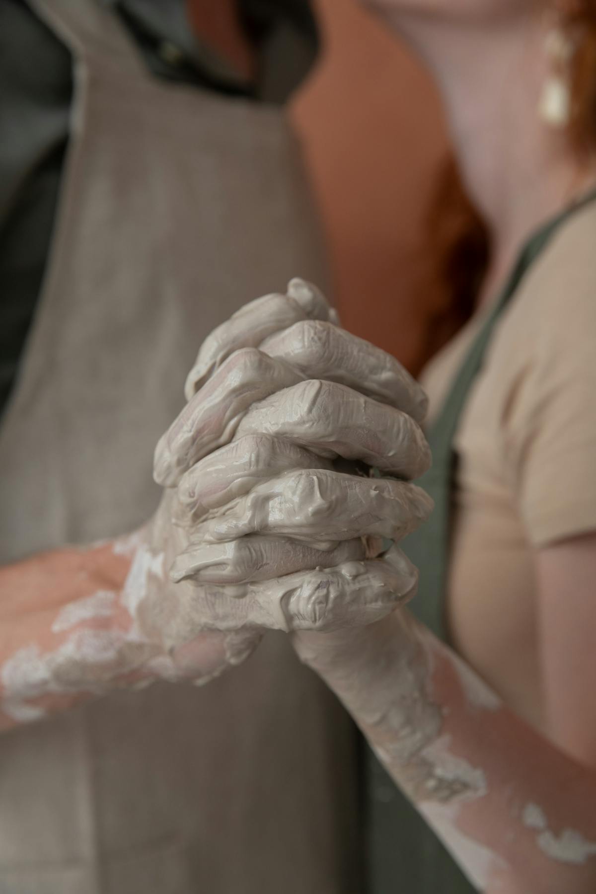 Crop couple holding hands in argilla