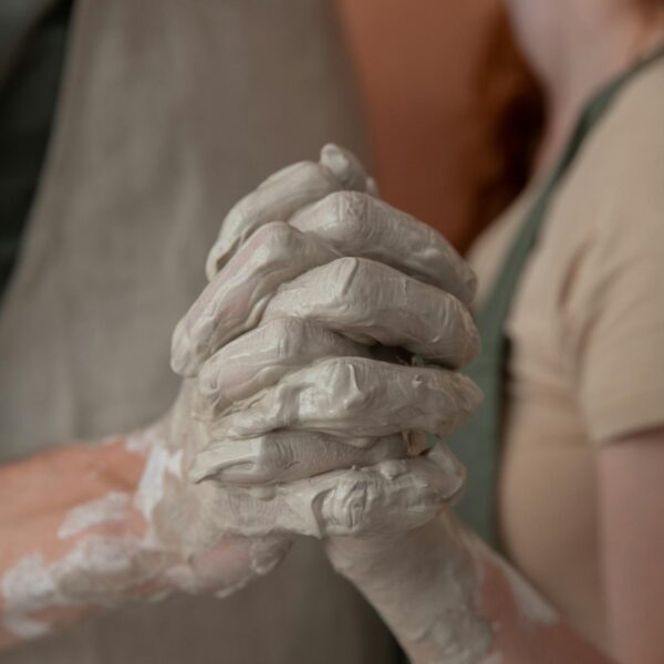 Crop couple holding hands in argilla